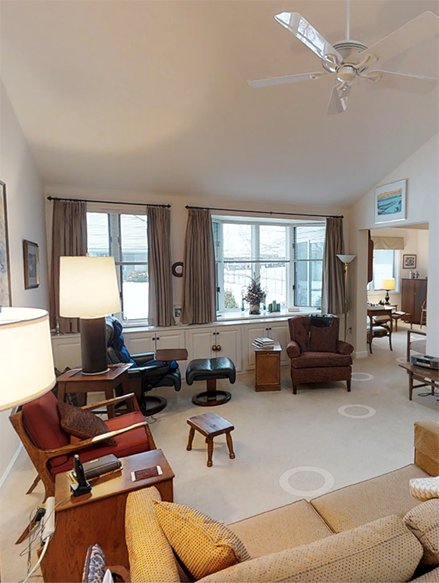 Bright and open living room with built-in cabinets and vaulted ceilings in a Two Bedroom Cottage.